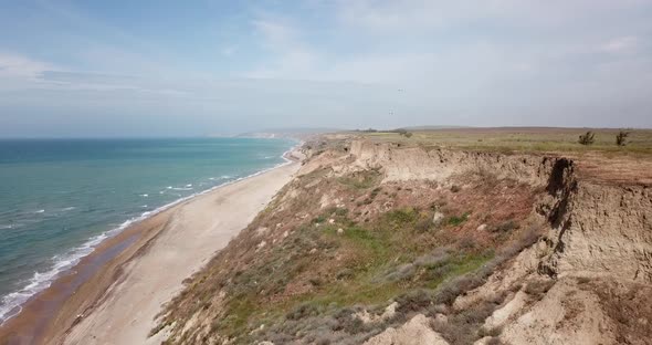 Tropical Beach Video, Aerial Bird Eye View of Blue Foaming Ocean Waves Crushing Against the Coast alt