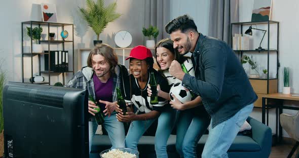 Friends Supporting Favourite Team and Rejoyced Scored Goal when Supporting Team at Home alt