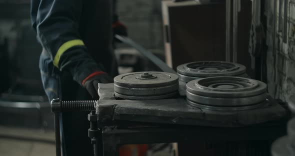 Locksmith Bends a Metal Profile Along a Certain Radius on a Bending Machine Metalwork at Blacksmith alt
