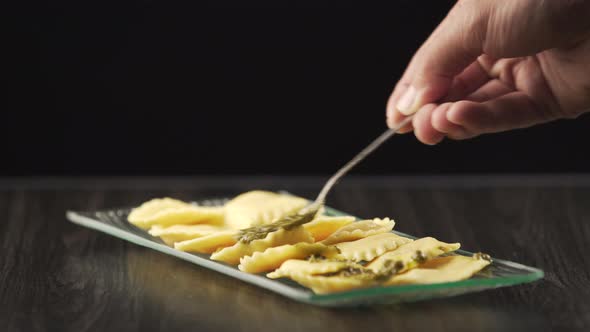 A cook finishes decorating the perfect dish for his gourmet kitchen. alt