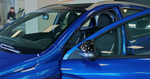 Young Businessman Approaches a New Auto and Sits in It Looks at the Interior of the Car Holds the alt