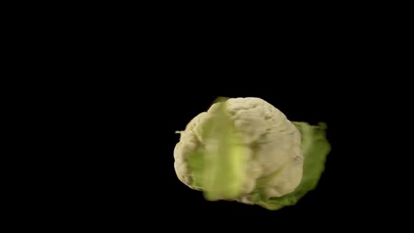 Dancing cauliflower on black background suspended on nothing. Creative food art. alt
