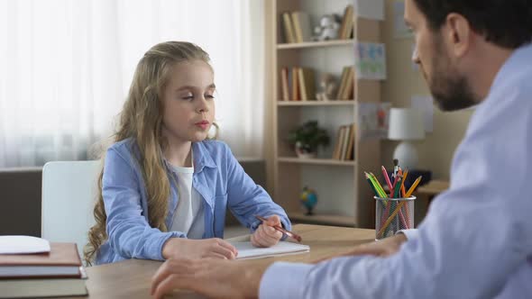 Demanding Father Making His Little Daughter Doing Homework, Home Schooling alt