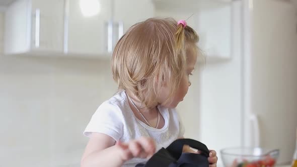 Cute Little Baby Uses a Virtual Reality Glasses in The Kitchen.