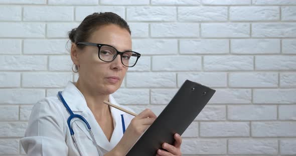 Doctor paper work at clinic.  alt