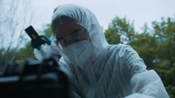 Criminalists Discovering Knife at Crime Scene Closeup Taking Evidence From Accident Murder alt