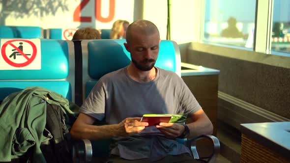 Airport and Travel View of Male Passenger Waiting for Flight and Sitting at Terminal Room Spbd alt