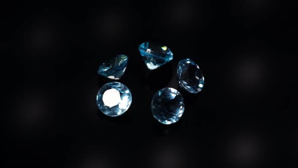 Natural Blue Topaz Gemstones on the Dark Background Turning Table