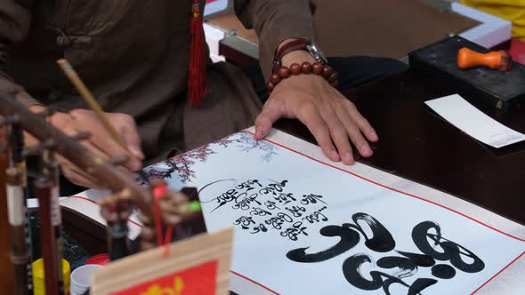 Vietnamese scholar writing calligraphy at lunar new year
