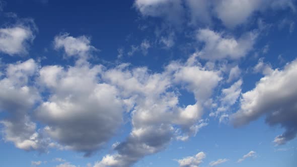 Cirrus Clouds in a Clear Blue Sky. White Clouds Move Across the Sky in Spring. alt