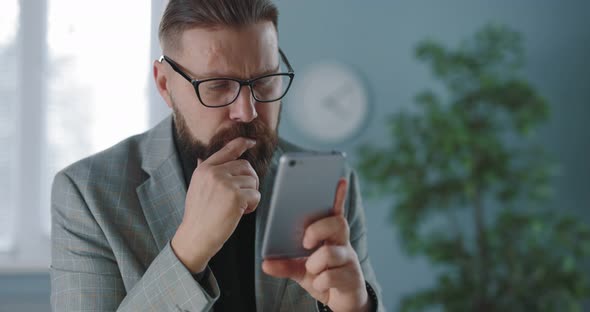 Man with Smartphone at Office