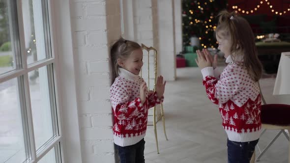 Cheerful Sisters Playing Hand Clapping Game.