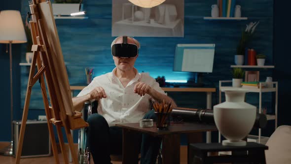 Old Person with Disability in Wheelchair Using Vr Glasses alt