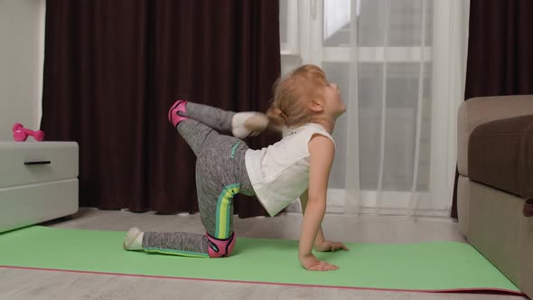 Child Kid Training Gymnastics Stretching at Home Children Girl Making Sport Workout Exercises by SkelDry 