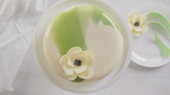 Time lapse. Step by step. Decorating mousse cake with white and green mirror glaze with white chocol alt