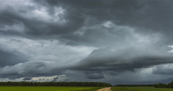Atmospheric Storm Clouds Fast Moving Over the Ground. Climate Change and Global Warming alt