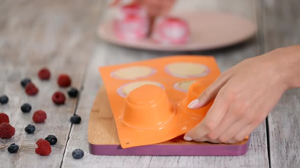 Chef Takes Away Frozen Berries Cakes From Confectionery Form alt