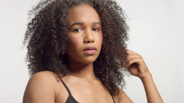 Closeup Portrait s of Young Mixed Race Model with Curly Hair in Studio with Natural Neutral Makeup