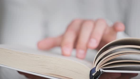 Reading a Book and Turning the Pages Close Up Slow Motion alt