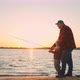 Old Fisher is Teaching His Grandson to Fish Grandfather and Little Child are Standing on Shore - VideoHive Item for Sale