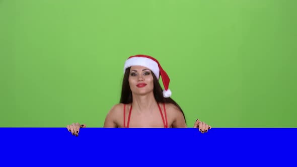 Santas Assistant Looks Out of the Blue Board and Shows a Thumbs Down. Green Screen. Slow Motion alt