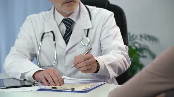 Doctor Consulting Female Patient in Clinic, Writing Down Prescription, Diagnosis alt