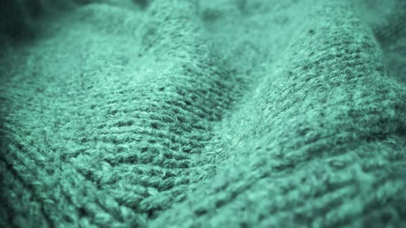 Extreme detail view of sheep wool cloth texture flowing in macro dolly shot. alt