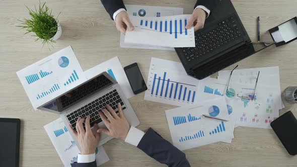 Two Busy Managers Working on Computers, Discussing Project Together, Top View alt