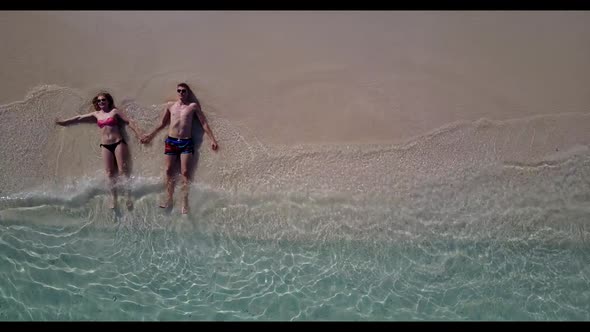 Young couple in love on paradise sea view beach holiday by aqua blue water and white sandy backgroun alt