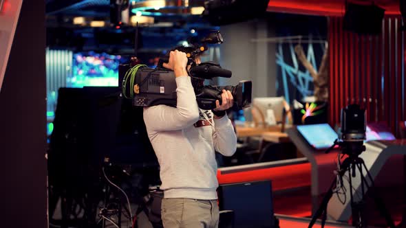 Making TV Show Or Film. Cameraman Working In TV Studio Video Production Filming Interview. alt