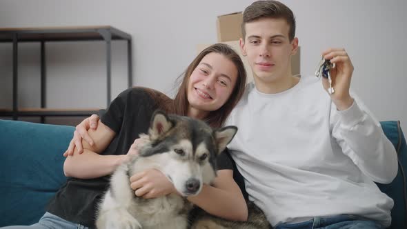 A Lean Man Gently Hugs His Cheerful Girlfriend alt