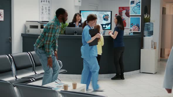 Many Diverse People Waiting to Write Medical Report at Reception Desk alt
