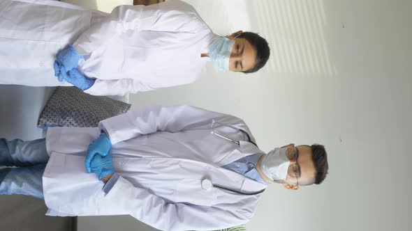 Portrait of Two Doctors A Man and a Woman Looking at the Camera, Dressed in Dressing Gowns alt
