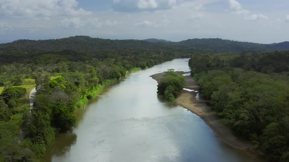 Aerial Drone View of Rainforest River and Mountains Scenery in Costa Rica at Boca Tapada, San Carlos alt