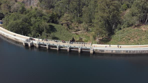 Fly over barrage in Munnar, India. People and cars crossing over. alt