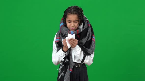 Front View of Sad Ill Teenage Girl Sneezing on Green Screen Looking at Camera with Upset Facial alt