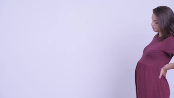 Young Tired Pregnant Woman Walking While Having Back Pain alt