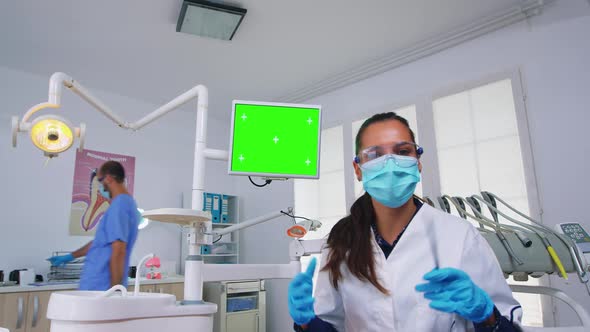 Patient Pov of Dentist Explaining Problem Using Greenscreen Monitor alt