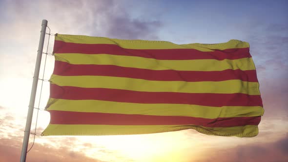 Roussillon flag, France, waving in the wind, sky and sun background alt