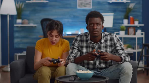 Modern Interracial Couple Losing Video Game on TV alt