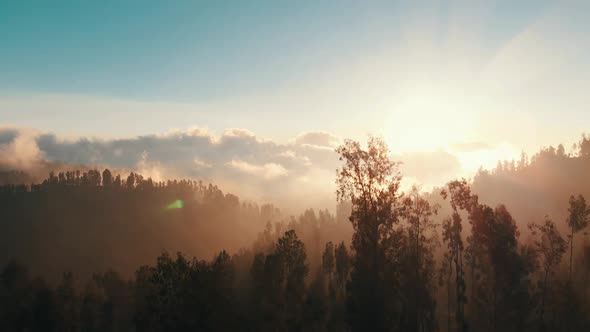 Beautiful cinematic aerial view video clip of a golden hour sunset from above mountains