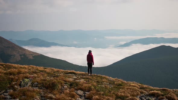 Time Lapse. Woman Standing in Mountain Peak. Amazing Landscape in Mountains alt