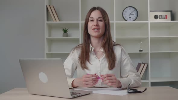 Smiling Young Business Woman Influencer Recording Video Blog Sitting at Home Office Desk alt