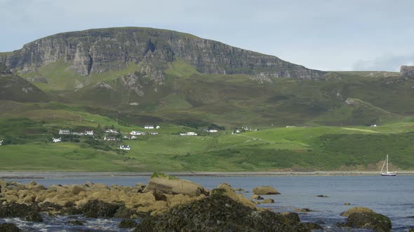 An island with hills by the water alt