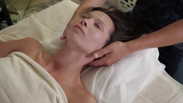 Man Massages a Woman Paying Attention To an Area of the Shoulder and Neck-collar alt