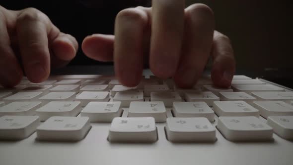 Close-up typing on keyboard with man fingers. Macro soft focus dolly shot. alt