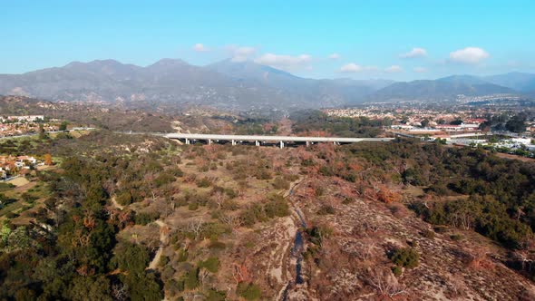 Aerial fly into bridge with a mountain background. alt