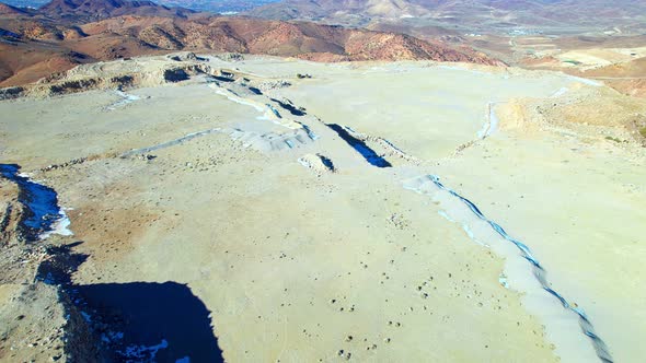 Aerial view over flat surface on a mountain peak in a desert landscape, Nevada alt