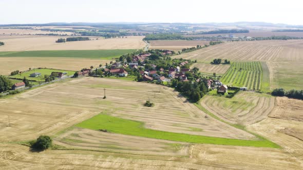 Aerial Drone Shot  a Village Surrounded By Fields and Forests in a Rural Area alt