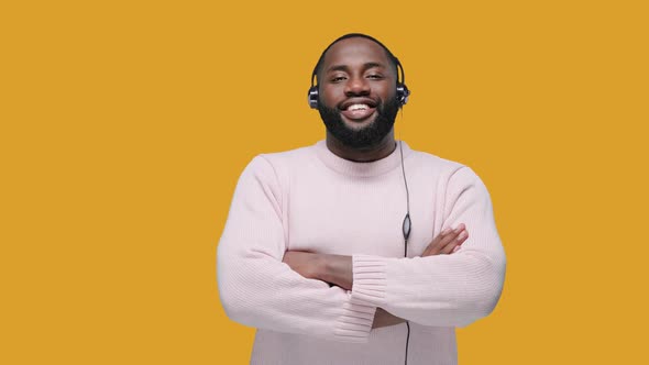 Smiling African American Man Wearing Wireless Headset Looking at the Camera, Call Center Service alt